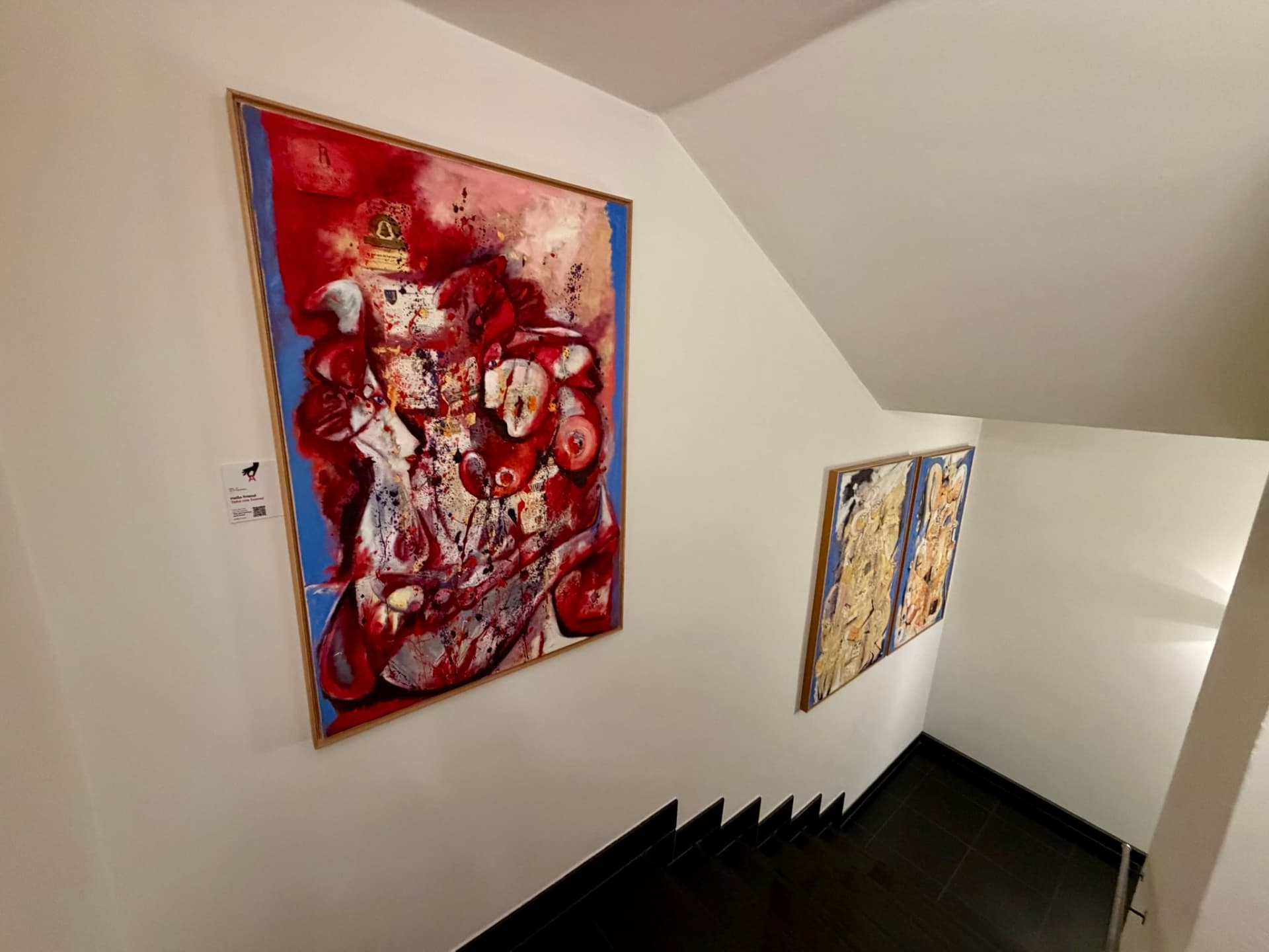 Artworks with PickArt QR labels displayed on a gallery wall